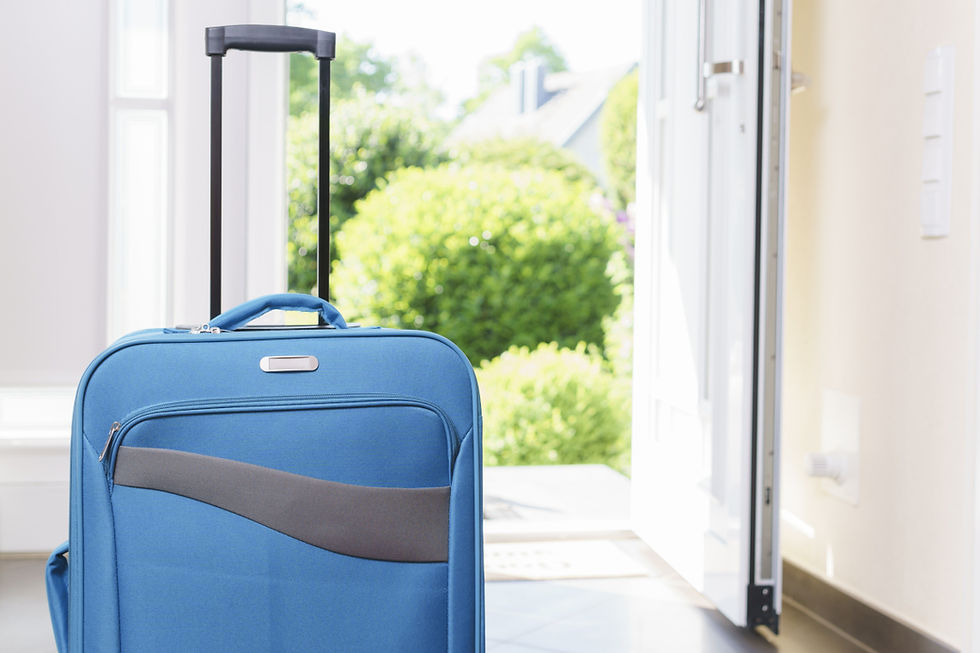 A blue suitcase near an open front door.