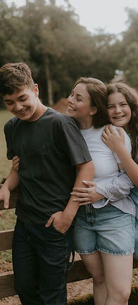 Family embraces and smiles together in nature_edited.jpg