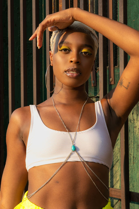 two girls in vibrant fashionable neon street wear walking through DTLA near sunset. There is also  a GIF of the girls walking and getting honked at. 