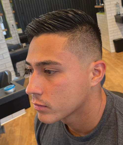 Classic men’s slick back haircut with skin fade at R&R Head Labs Denver barbershop