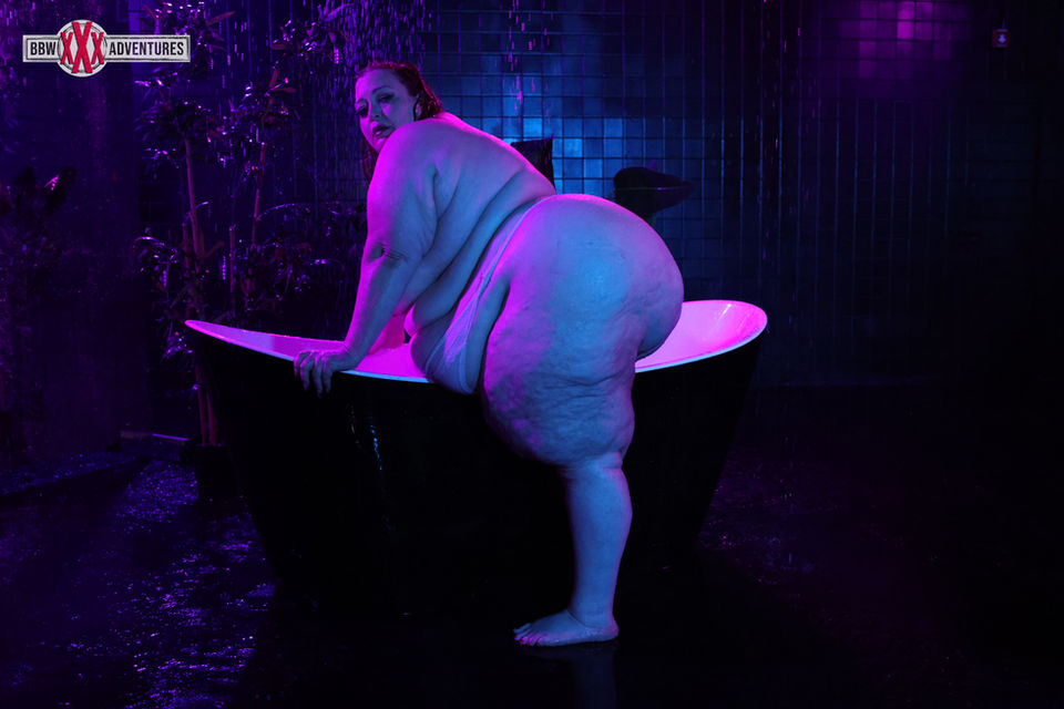 a woman in a bathtub with a sign that says ' s ' on it