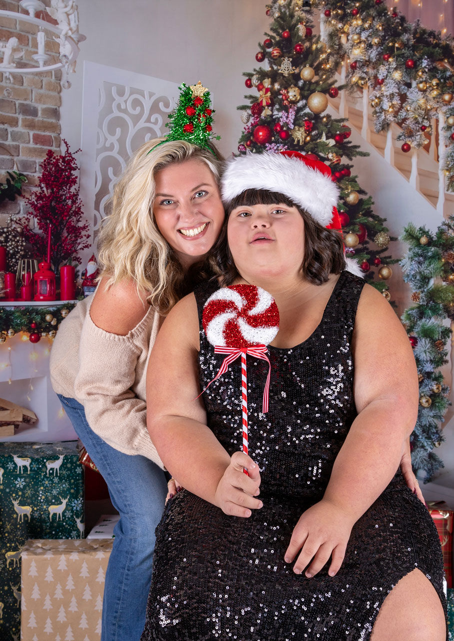Mother and daughter sitting in the studio Christmas photo scene.