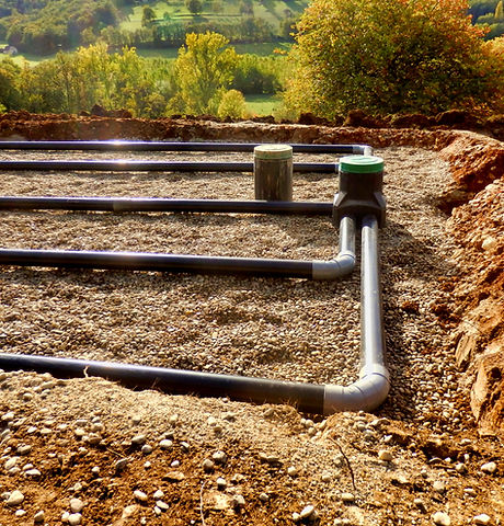 The top layer of pipework, after the membrane, sand and gravel had been applied, during th