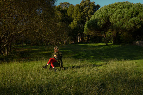 Girl sitting in the middle of a field