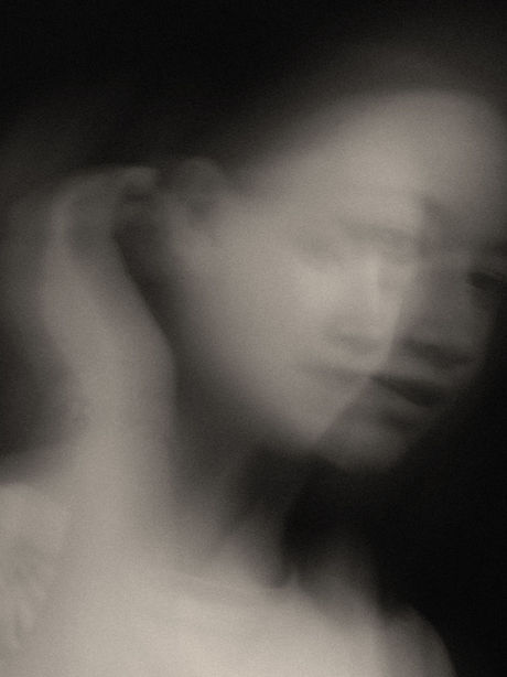 Double-exposure portrait of a distressed woman, her face obscured, evoking the loss of identity within a damaging family system.