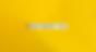 Tiles spelling "BELONGING" on a bright yellow background. The image conveys a sense of inclusion and positivity through its bold color.