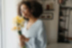 side-view-black-smiling-woman-smell-flowers.jpg