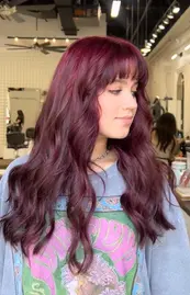 Red Violet Hair Color with soft waves at Hello Beautiful Salon Houston