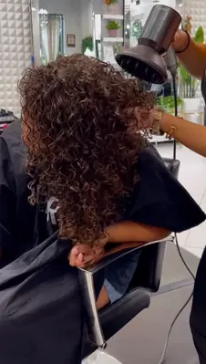 Curly hair styled with diffuser at Hello Beautiful Salon Houston