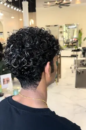 Man with fresh curly haircut at Hello Beautiful Signature Salon Houston