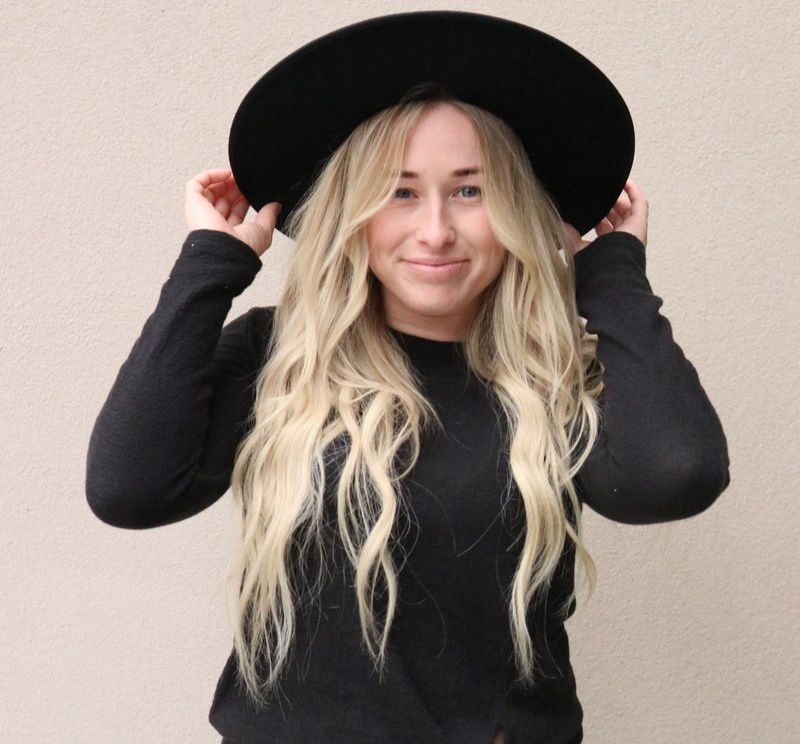 Smiling client with blonde hair extensions at Hello Beautiful Signature Salon near Sugar Land TX