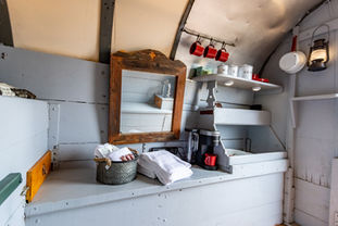 Kitchenette area within the Wild West Wagon, skillfully incorporating modern culinary amenities into the historically themed interior.