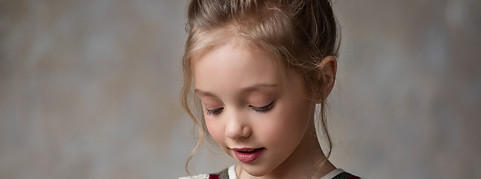 girl is a lace trimmed dress