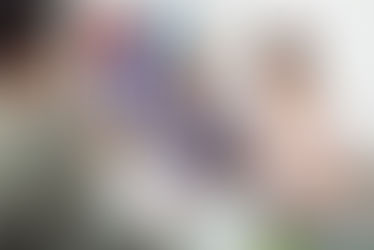 A teacher meeting with a young child and a mother.