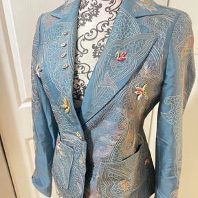 A powder-blue blazer with hip pockets and intricate multi-colored paisley embroidery all over.