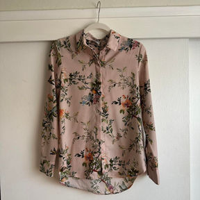 A mauve long-sleeve button-up with colorful realistic florals.