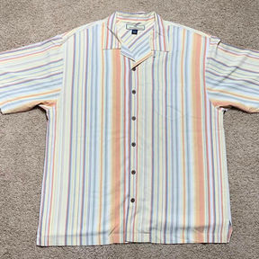 A white linen button-up t-shirt with vertical multi-color pastel stripes.