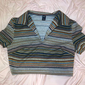 An earth tone striped t-shirt with a v-neck collar.