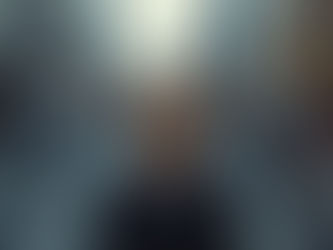 A woman standing still in a chaotic street, eyes closed, centered and calm while the world moves fast around her — captured in a moment of inner clarity.