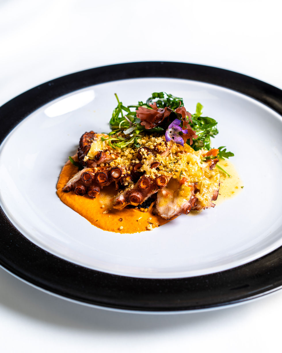 Neatly plated dish featuring panko encrusted octopus