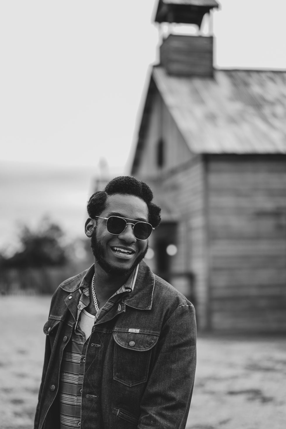 Singer Leon Bridges smiling during the filming of the b-sides music video featuring Khruangbin