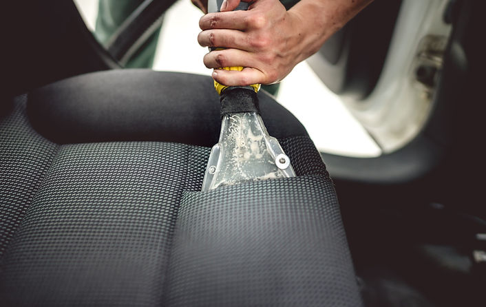 Detailing on interior of modern car. Details of upholstery vacuuming.jpg