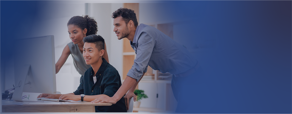 Team of three colleagues collaborating at a computer in a modern office, working together on a project with focus and teamwork.