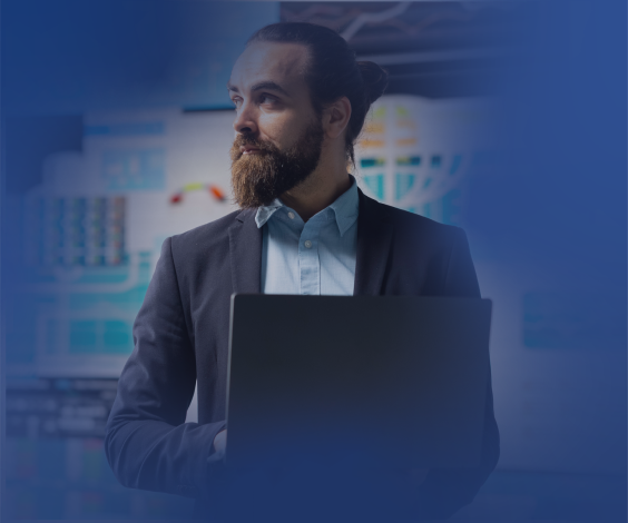 Financial analyst with laptop reviewing digital dashboards and data charts.