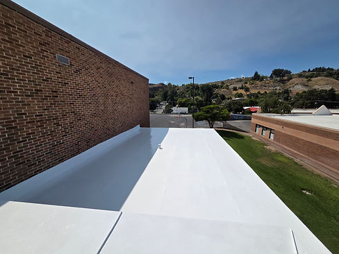 Coated flat roof on a brick commercial building