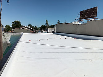 New white flat roof on a commercial building