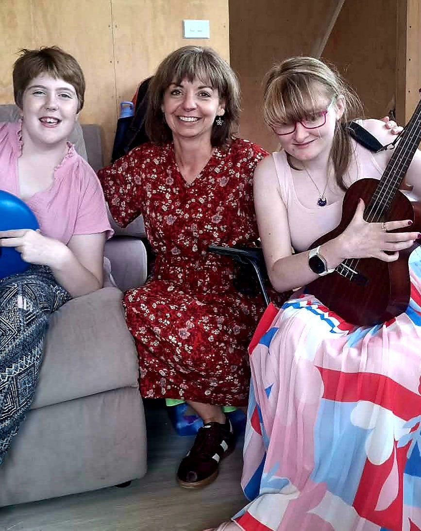 people smiling for the camera enjoying music