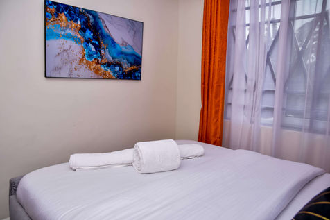 Bright modern bedroom in furnished apartment