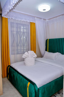 Elegant green bedroom in furnished apartment