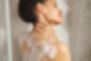 a-woman-lathers-soap-on-her-shoulder-while-taking-2025-01-21-22-23-13-utc.jpg