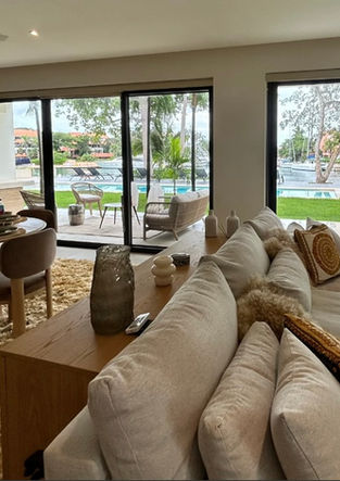 Soft, airy living space designed to capture the relaxed luxury of the Riviera Maya with warm natural light and layered neutra