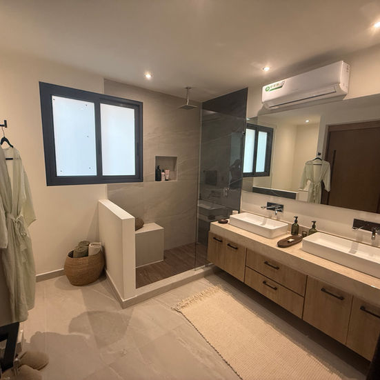 Modern custom-built bathroom featuring bespoke cabinetry, curated stonework, and refined finishes designed for a minimal, ser
