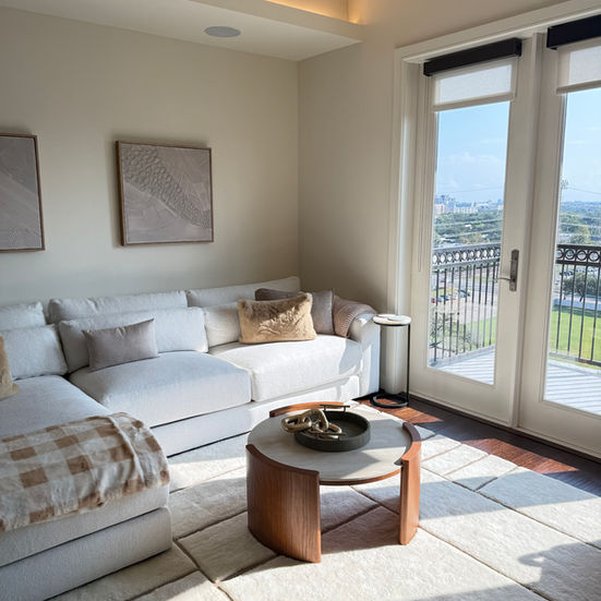 Organic modern living room design featuring warm neutrals, natural textures, and inviting, sunlit ambience.