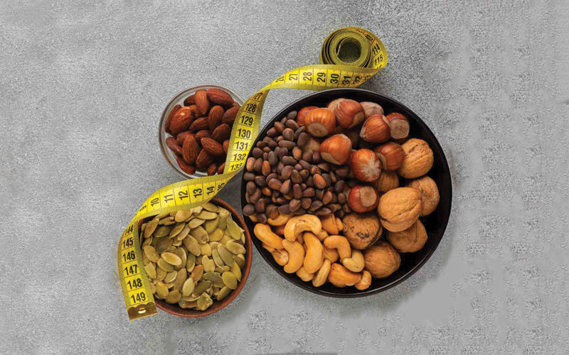 Bowl of mixed dry fruits including almonds, cashews, walnuts, khajoor, and anjeer, a perfect high-calorie snack for natural weight gain and energy boost with FlavoFarm’s premium selection