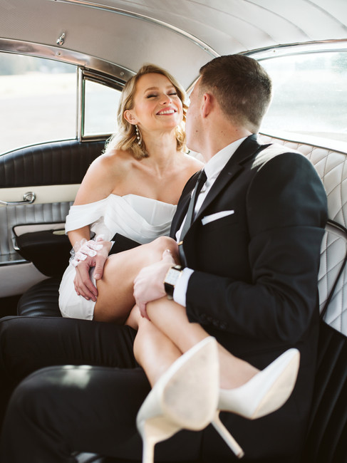 Leaning in for a Kiss. A Portland photographer captures a couple in a vintage cadillac.