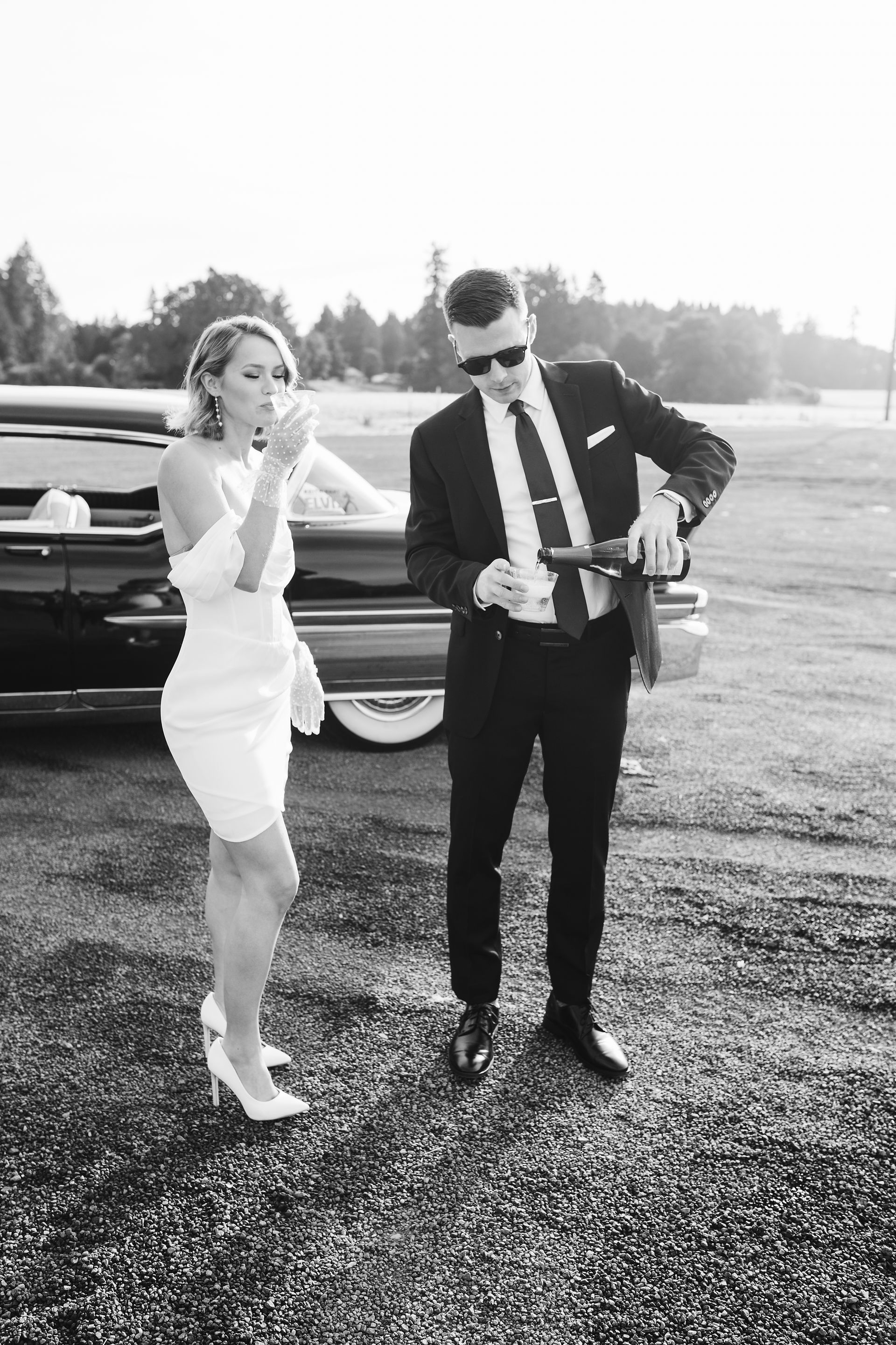 A Portland photographer captures a couple sipping champagne in a vintage cadillac.