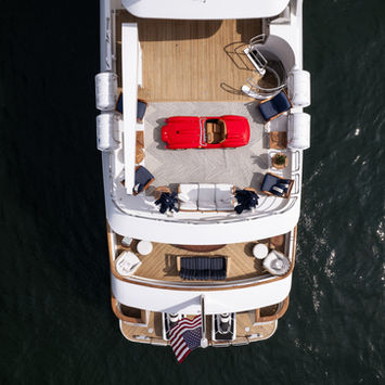 Top-down view of a red Ferrari Testa Rossa J on a luxury yacht deck for Rennauto Brisbane.