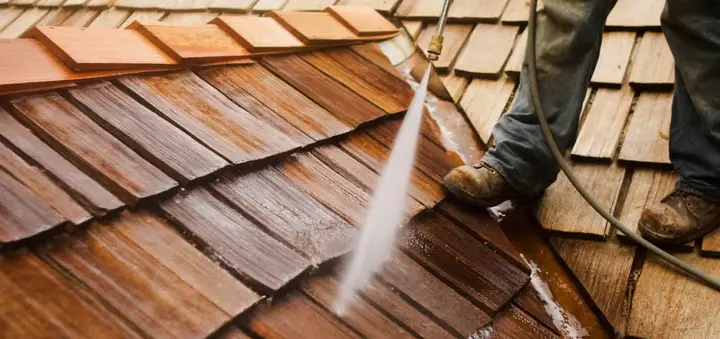 man-pressure-washing-a-roof-picture