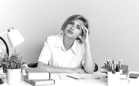 tired-young-blonde-student-girl-sitting-desk-with-school-tools-keeping-hand-head-looking-c