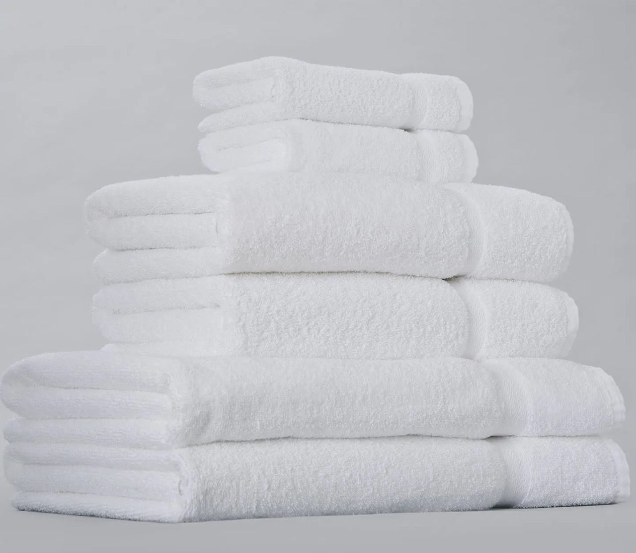 Stack of white bath towels and washcloths