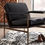 Thumbnail: A black leather accent chair on top of an area rug
