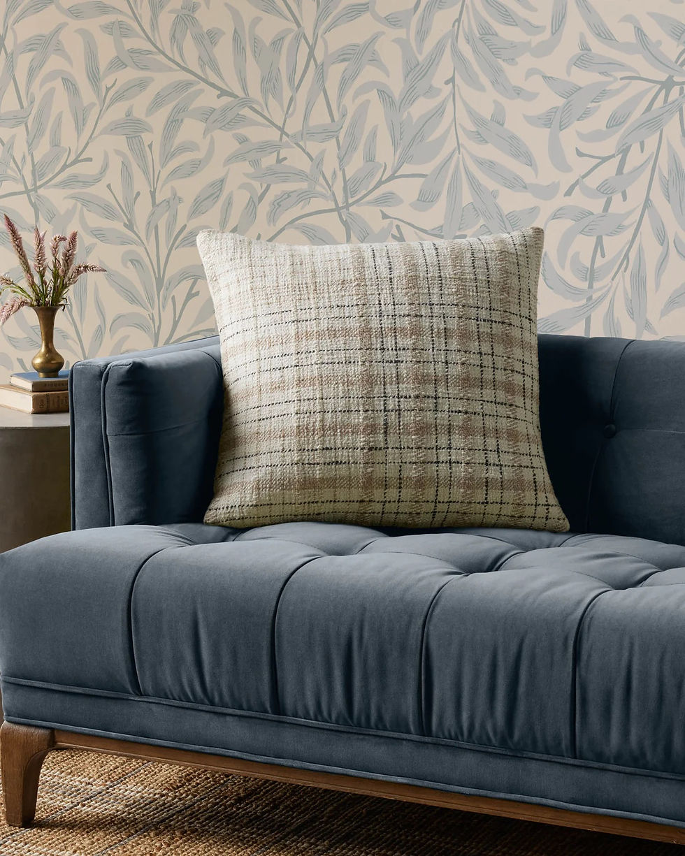 beige throw pillow on a dark gray sofa