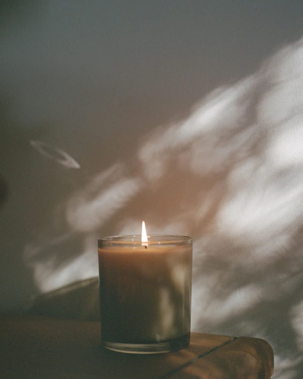 Thumbnail: Lavune no 9 Santal candle burning on a table in a beige glass jar