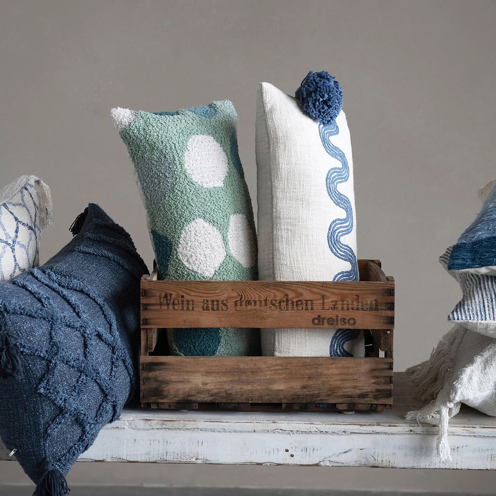 green lumbar pillow in a basket on display