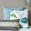 Thumbnail: Thow pillows arranged on a bench seat featuring a navy blue and white throw pillow with geometric design