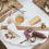 Thumbnail: cheeses and meats on a charcuterie board